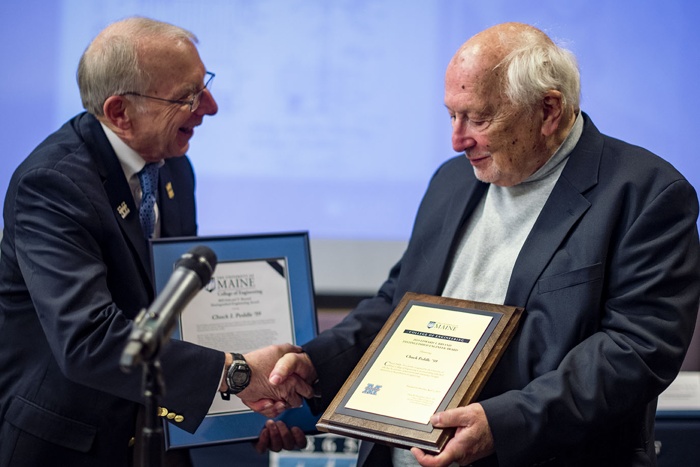 Dean Dana Humphrey shakes hands with Chuck Peddle.