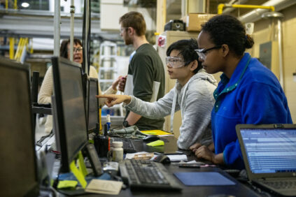 Two students monitor telemetry at the Process Development Center.