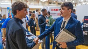 A photo of a student and an employer interacting at UMaine's engineering career fair